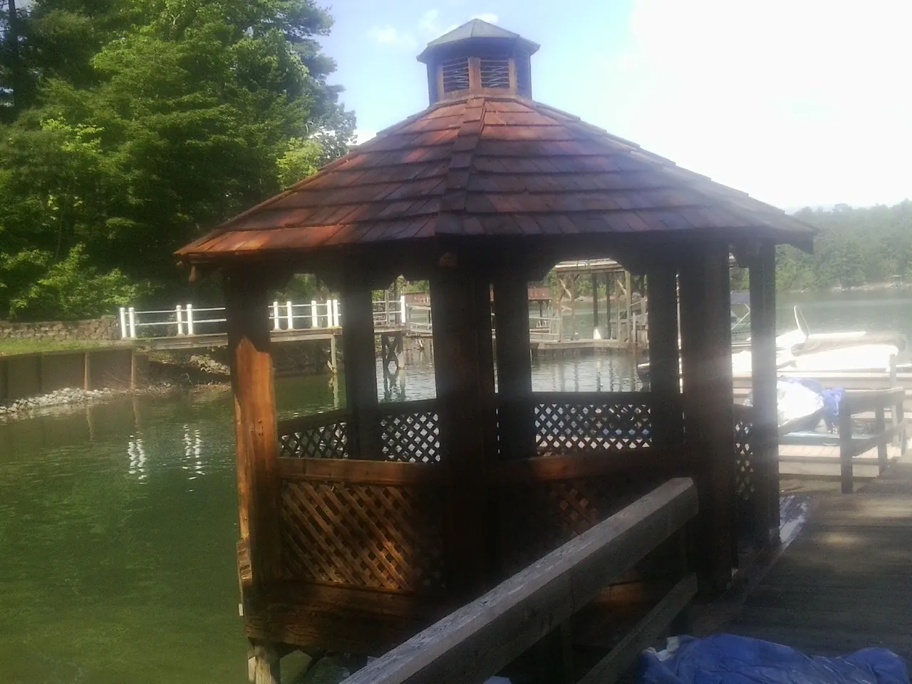 Cedar shake gazebo roof rebuilt on a lake dock in Scipio